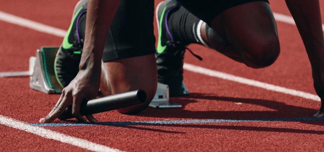 man on running field by Braden Collum courtesy of Unsplash.